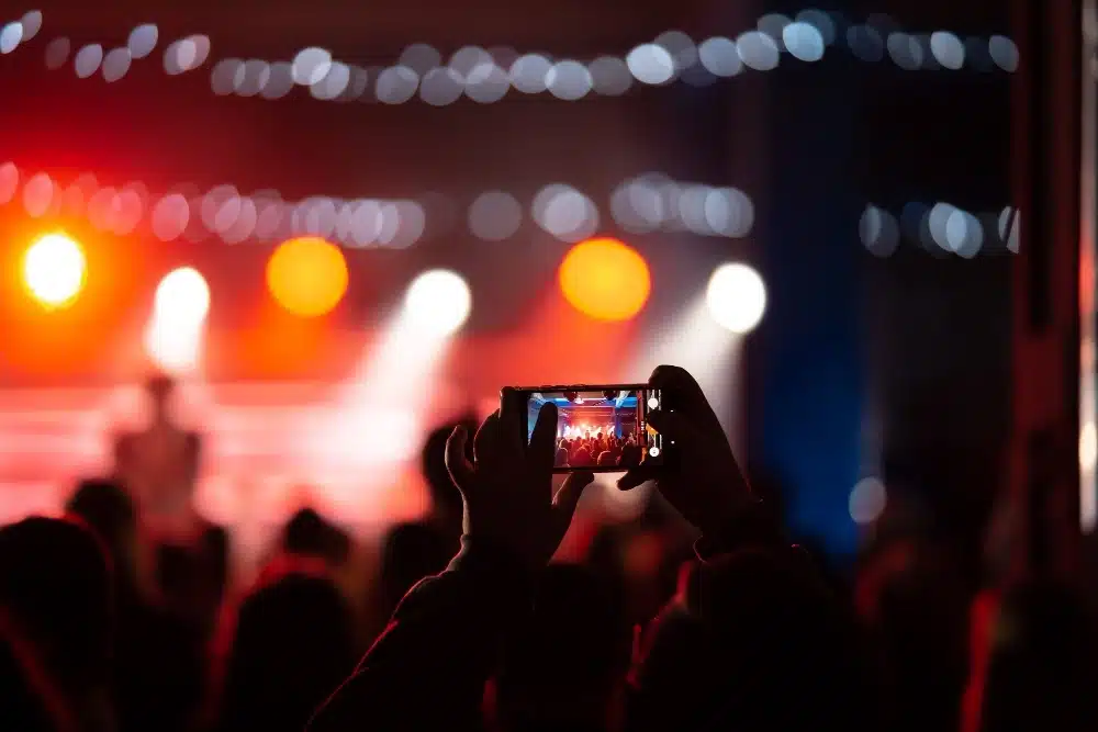 A vibrant event stage with colorful lights and an engaged audience