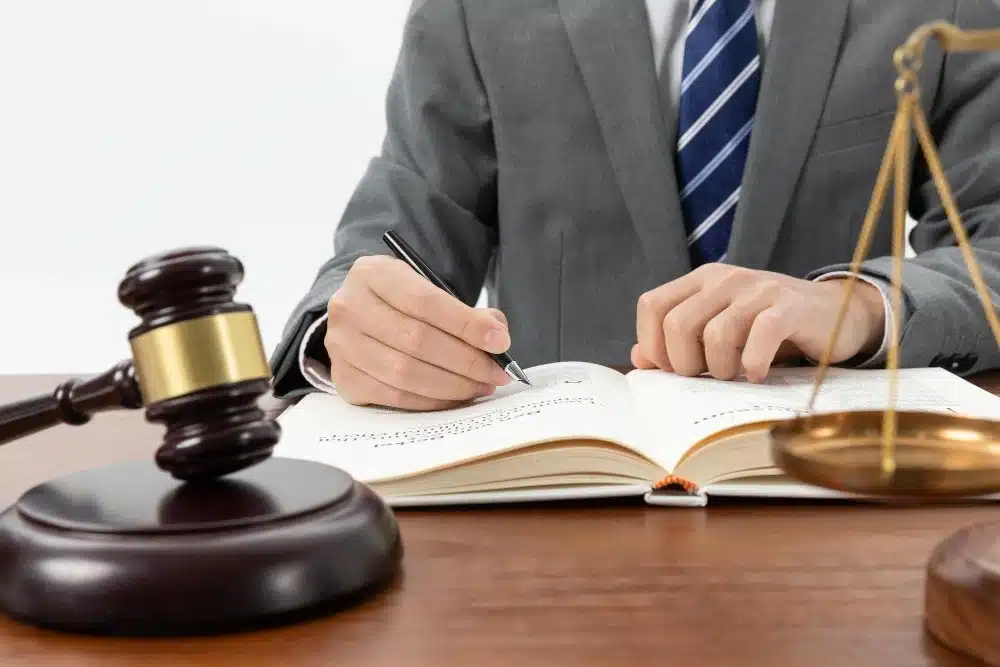 A professional lawyer reviewing documents with a client in an office.